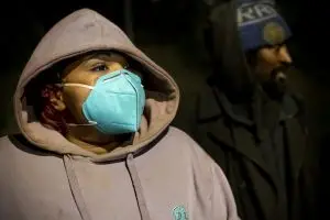 Rayna Burton, left, and Rocknie Simon, who are both experiencing homelessness speak to volunteers near where they are camping on X Street during the Homeless Point-In-Time (PIT) Count on Feb. 24, 2022