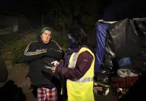 Jessica Hurd, left, who is experiencing homelessness speaks with Lourdes Castro Ramirez on X Street during the Homeless Point-In-Time (PIT) Count on Feb. 24, 2022. Ramirez is the Secretary of the California Business, Consumer Services & Housing Agency.