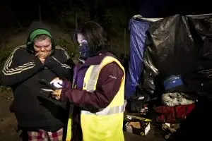 Jessica Hurd, left, who is experiencing homelessness speaks with Lourdes Castro Ramirez on X Street during the Homeless Point-In-Time (PIT) Count on Feb. 24, 2022. Ramirez is the Secretary of the California Business, Consumer Services & Housing Agency.